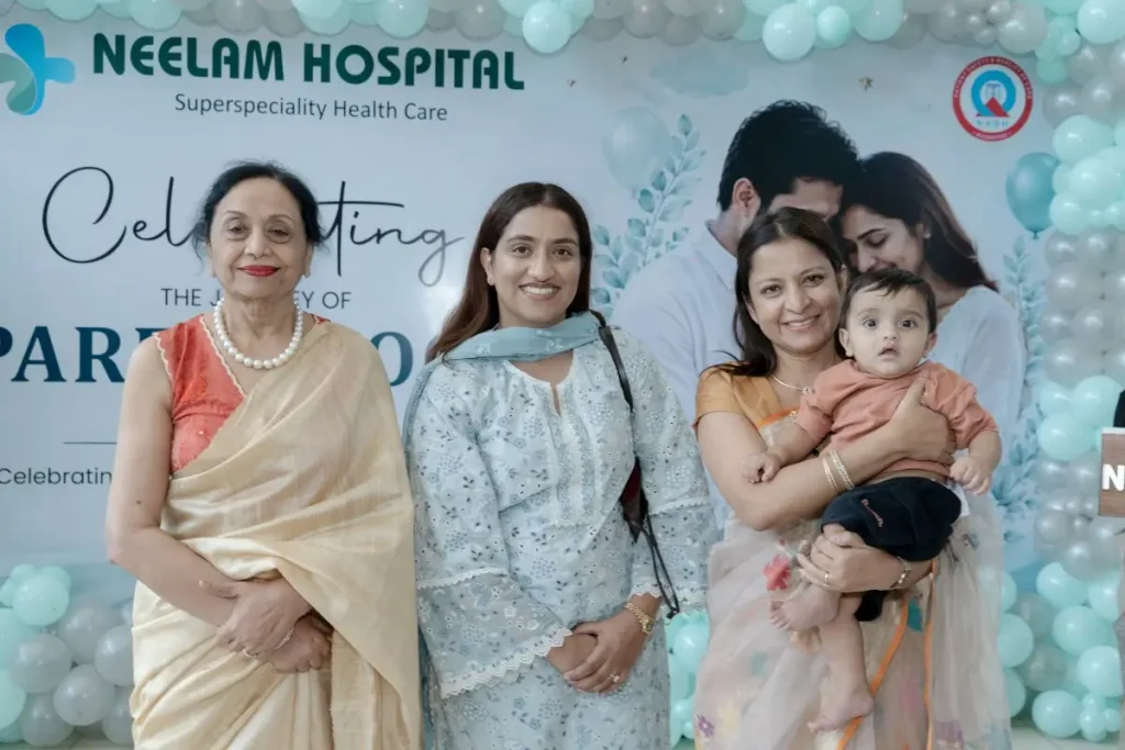 Dr. Shikha Gupta with Neelam Bansal, Dilpreet Dhillon's family, and their child during an IVF success celebration at Neelam Hospital, Rajpura, Punjab.