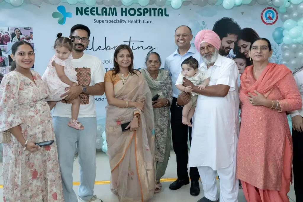 IVF patient family with Dr. Shikha Gupta during an IVF success celebration at Neelam Hospital, Rajpura, Punjab.